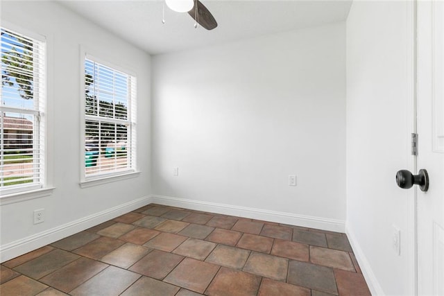 spare room with ceiling fan and a healthy amount of sunlight