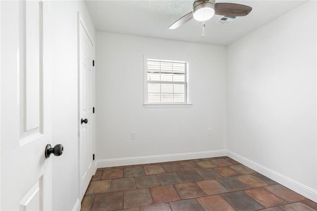 spare room with ceiling fan and a textured ceiling