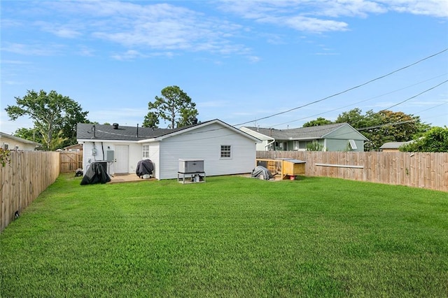 rear view of property with a lawn