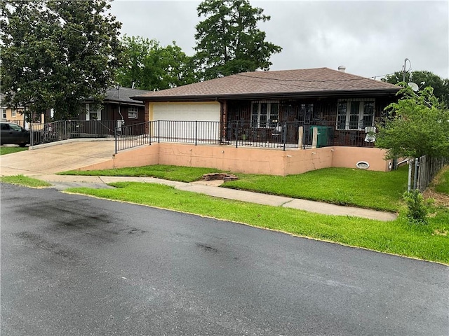 view of front of property with a front yard and a garage