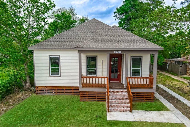 view of front of home with a porch and a front yard