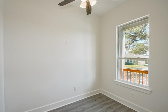 empty room featuring ceiling fan and dark hardwood / wood-style flooring