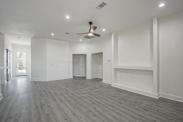 unfurnished living room with ceiling fan and hardwood / wood-style flooring