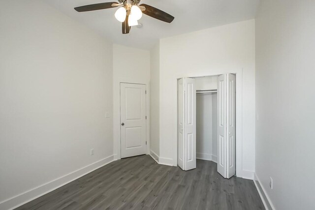 unfurnished bedroom with ceiling fan and dark hardwood / wood-style floors