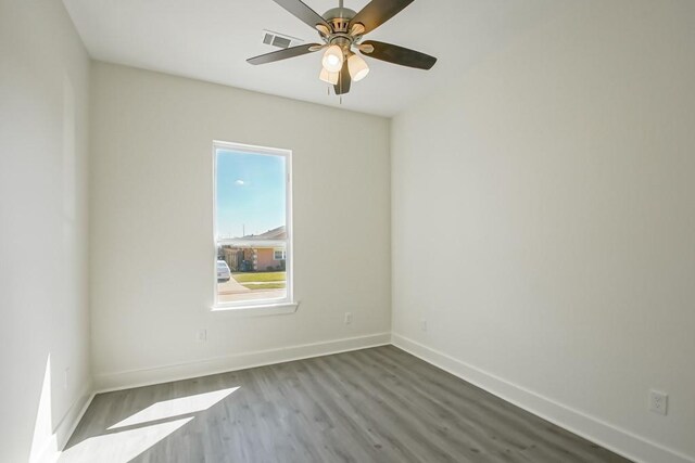 empty room featuring hardwood / wood-style flooring and ceiling fan