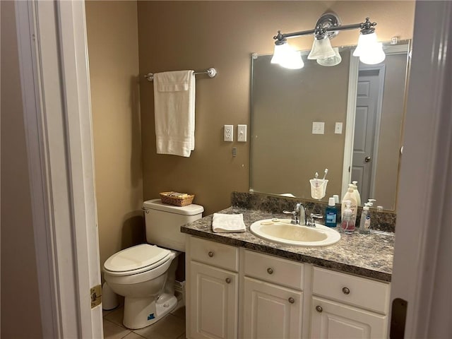 bathroom featuring tile patterned floors, toilet, and vanity