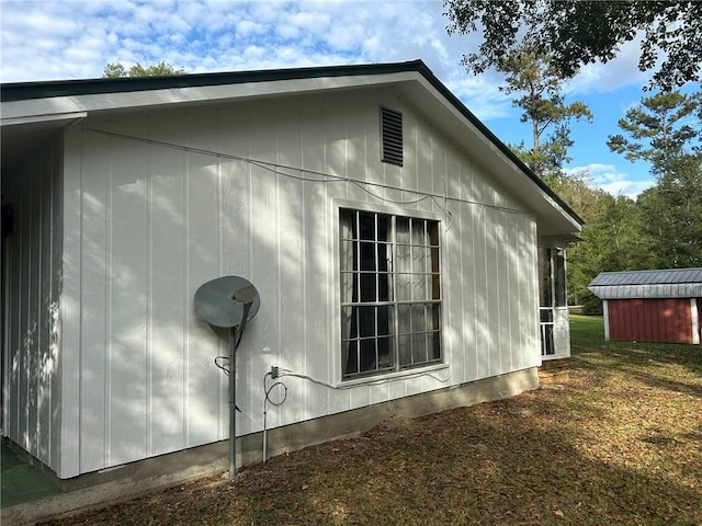 view of side of home with an outdoor structure and a shed