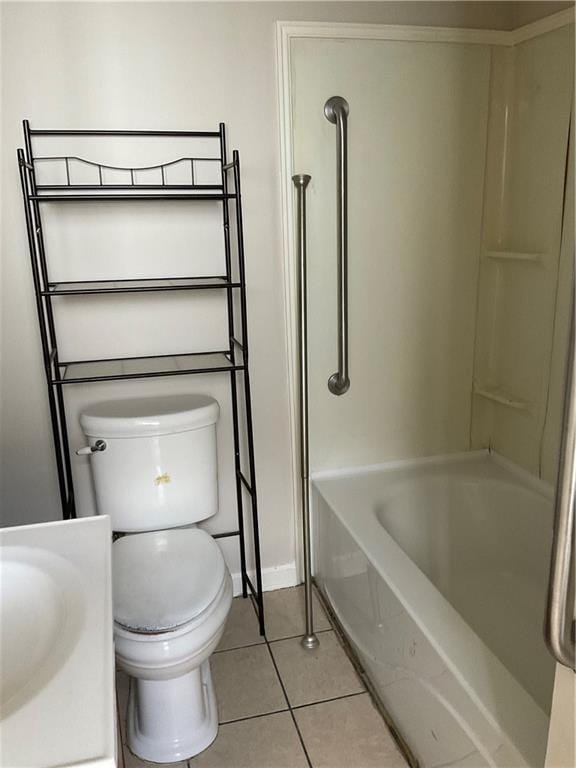 9009 Belfast St, New Orleans, LA 70118 - full bathroom with tile patterned floors, toilet, baseboards, vanity, and shower / washtub combination