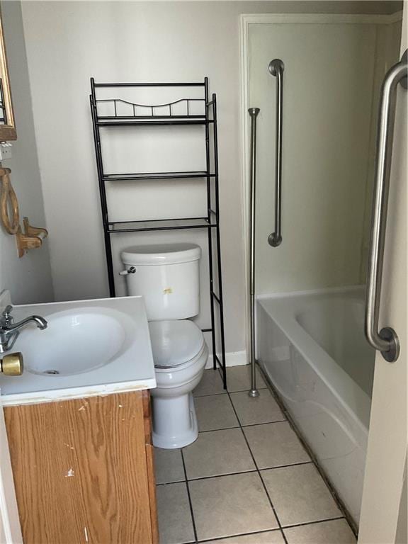 9009 Belfast St, New Orleans, LA 70118 - full bathroom with tile patterned flooring, toilet, vanity, baseboards, and shower / tub combination