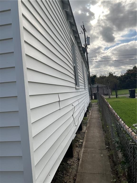 view of side of home featuring a lawn