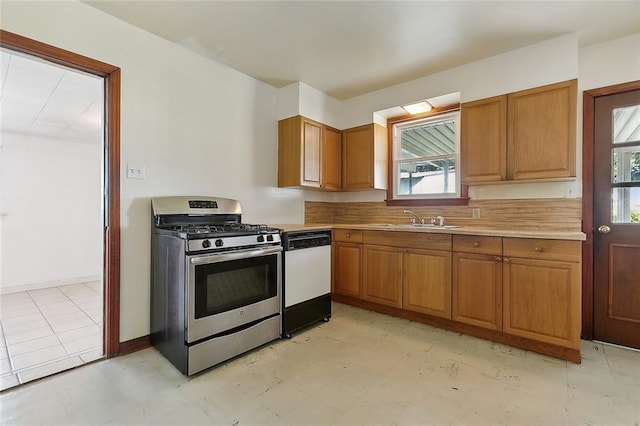 kitchen featuring dishwasher, sink, and gas range