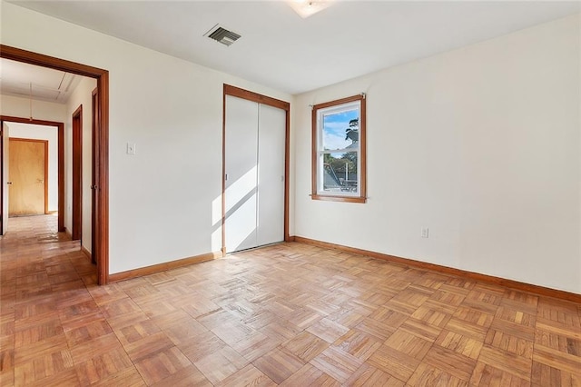 unfurnished room with light parquet flooring