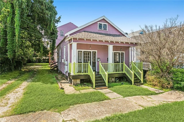 view of front of home with a front yard and a porch