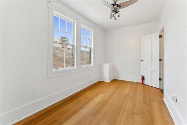 spare room with hardwood / wood-style floors and ceiling fan