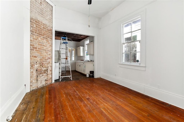 unfurnished living room with hardwood / wood-style flooring and sink