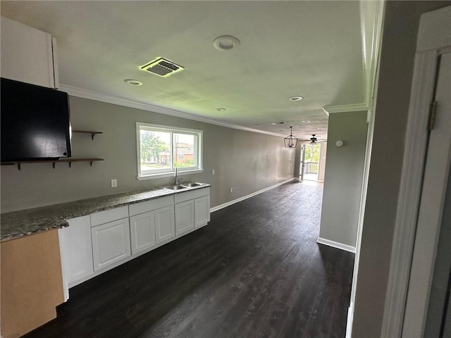 kitchen with ornamental molding, ceiling fan, dark wood-type flooring, sink, and white cabinets