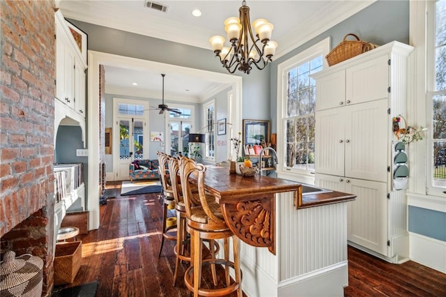 kitchen featuring white cabinets, pendant lighting, dark hardwood / wood-style floors, and plenty of natural light