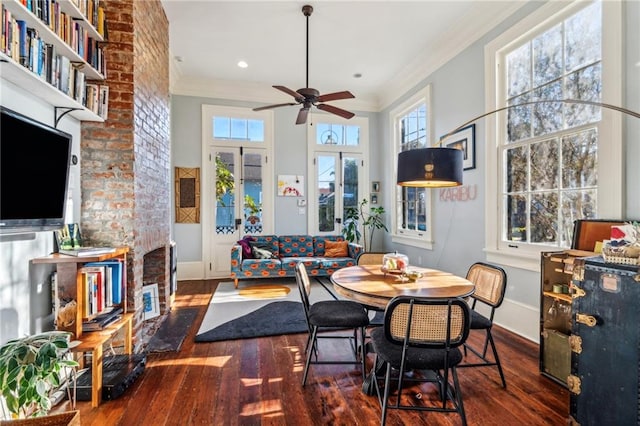 dining area featuring ceiling fan, dark wood-type flooring, and ornamental molding