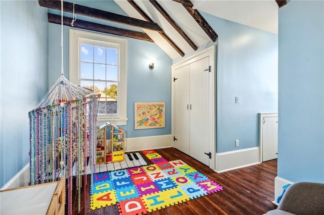 recreation room featuring vaulted ceiling with beams and dark wood-type flooring