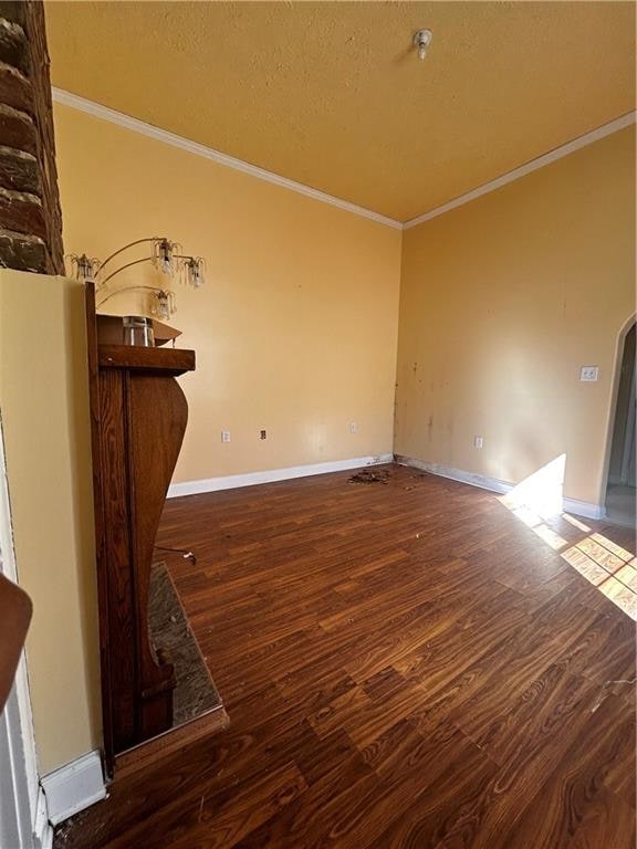 interior space with crown molding and dark hardwood / wood-style floors