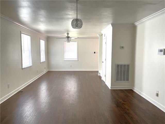 empty room featuring crown molding, dark hardwood / wood-style flooring, and ceiling fan