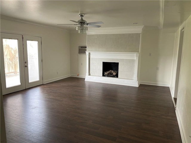 unfurnished living room with french doors, crown molding, ceiling fan, a fireplace, and dark hardwood / wood-style flooring