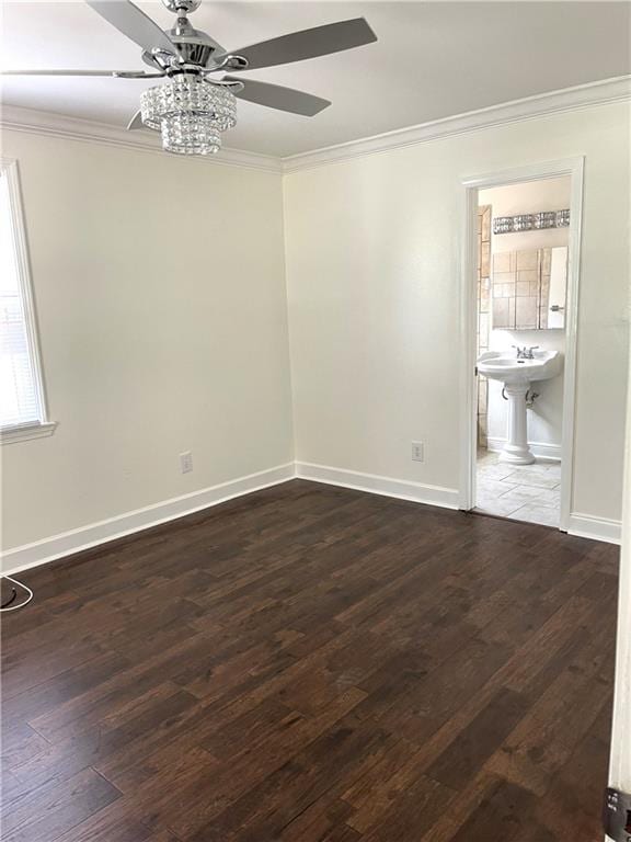 unfurnished room with ornamental molding, ceiling fan, and dark wood-type flooring