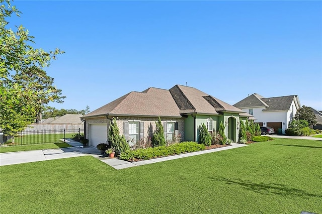 view of front of house with a garage and a front yard