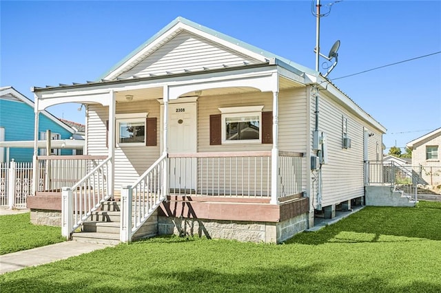 view of front facade with covered porch and a front yard