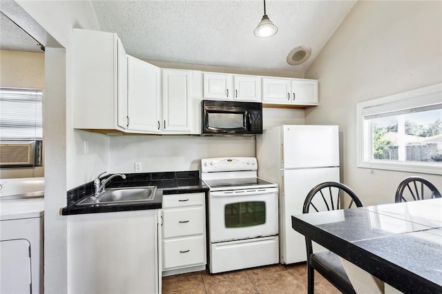 kitchen featuring washer / clothes dryer, pendant lighting, vaulted ceiling, white appliances, and white cabinets