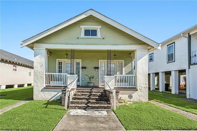 view of front of house with a front yard and a porch