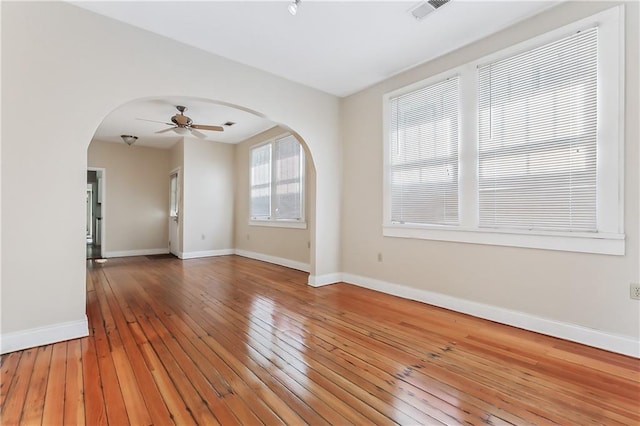 unfurnished room with ceiling fan and wood-type flooring