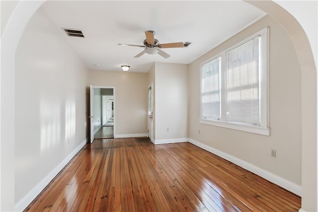 empty room with ceiling fan and hardwood / wood-style floors