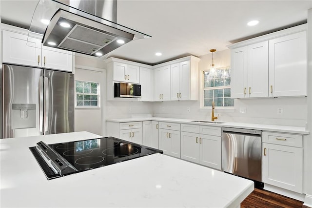 kitchen featuring pendant lighting, sink, white cabinets, and stainless steel appliances