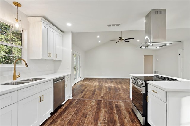 kitchen with lofted ceiling, white cabinets, sink, appliances with stainless steel finishes, and island exhaust hood