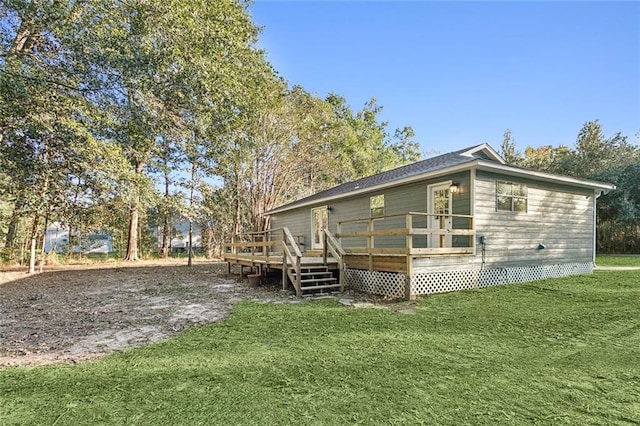 view of side of property featuring a deck and a yard