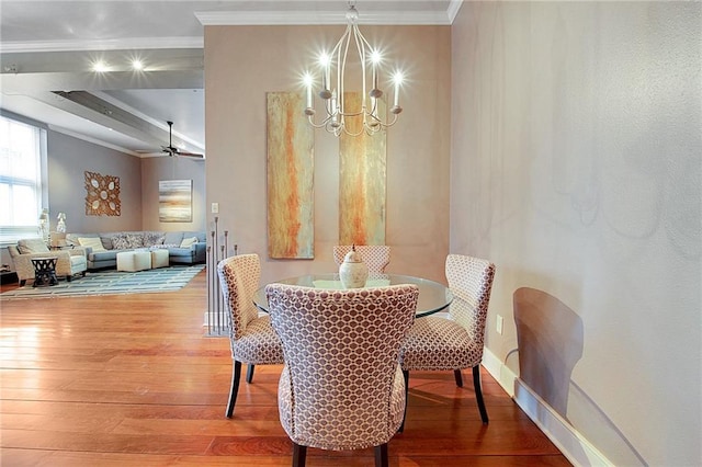 dining area with hardwood / wood-style floors, ceiling fan with notable chandelier, and ornamental molding