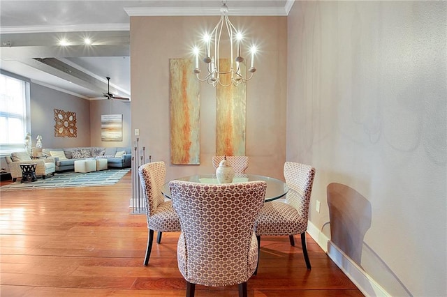 dining area featuring crown molding, baseboards, ceiling fan with notable chandelier, and hardwood / wood-style floors