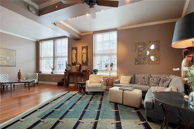 living room with a fireplace, wood-type flooring, ceiling fan, and crown molding