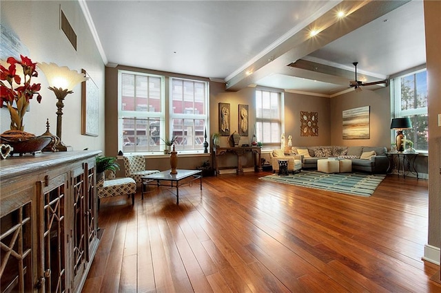 living room featuring crown molding, ceiling fan, visible vents, and hardwood / wood-style flooring
