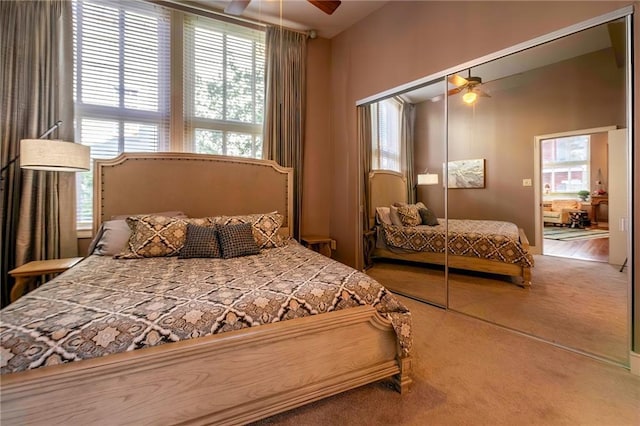 bedroom with a closet, carpet flooring, and a ceiling fan