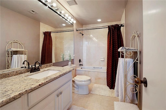 bathroom with tile patterned flooring, tiled shower / bath, toilet, and visible vents