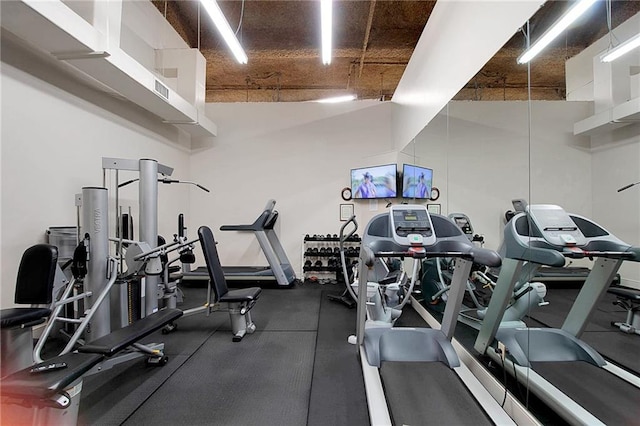 workout area with visible vents and a high ceiling