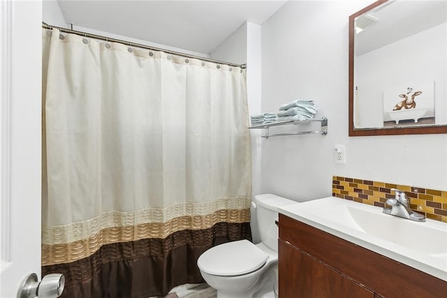 bathroom featuring decorative backsplash, toilet, and vanity