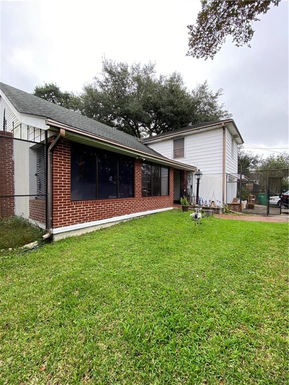 rear view of property with a yard