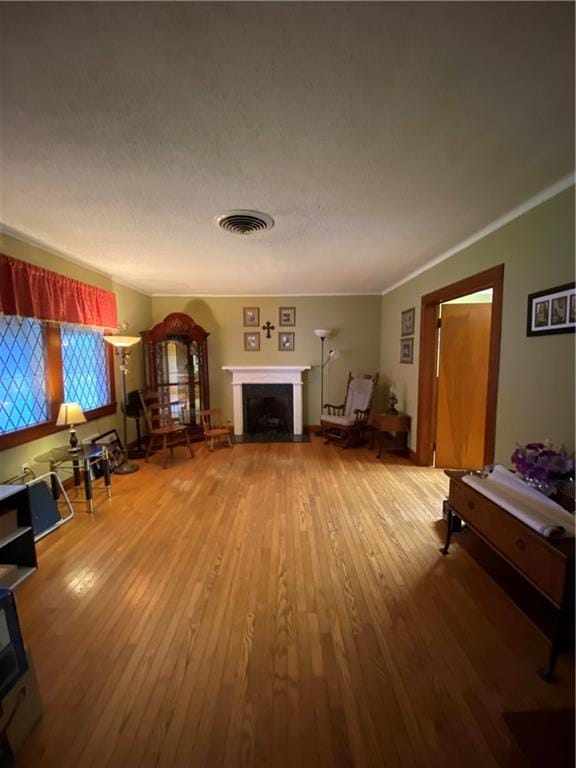 living room with hardwood / wood-style flooring and ornamental molding