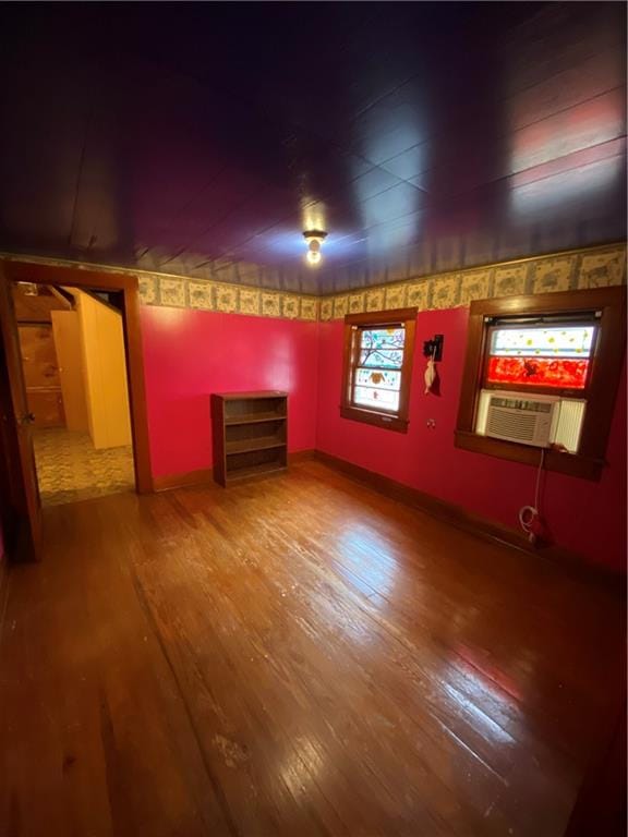 basement featuring hardwood / wood-style floors and cooling unit