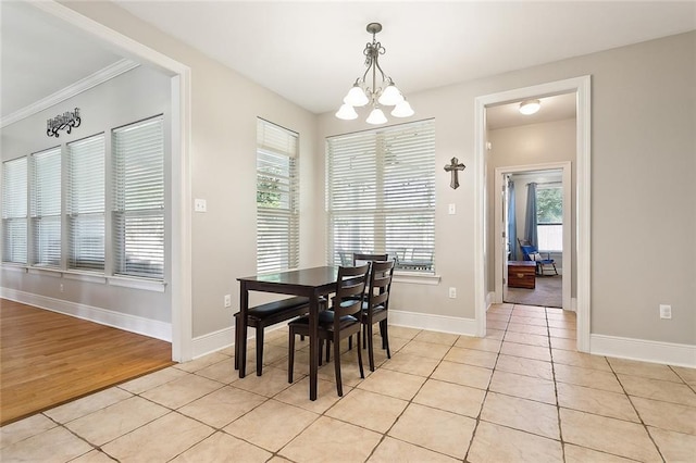 tiled dining space with a chandelier