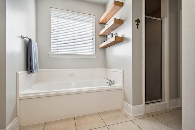 bathroom featuring tile patterned floors and shower with separate bathtub