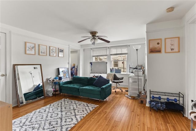 living room with hardwood / wood-style floors and ceiling fan